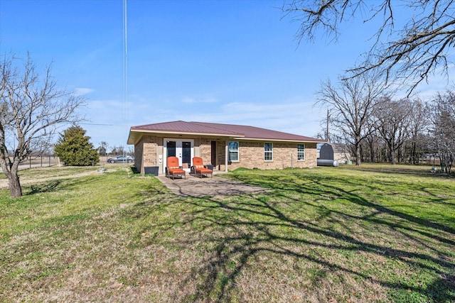 back of property featuring a patio area and a lawn