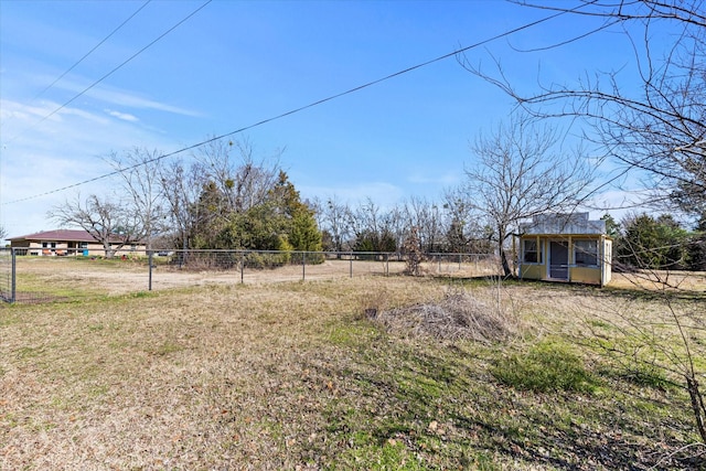 view of yard featuring a rural view and an outbuilding