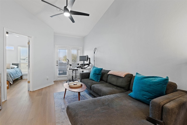 living room featuring ceiling fan, high vaulted ceiling, and light hardwood / wood-style flooring