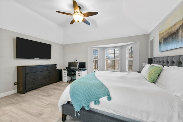 bedroom with light hardwood / wood-style flooring, vaulted ceiling, and ceiling fan