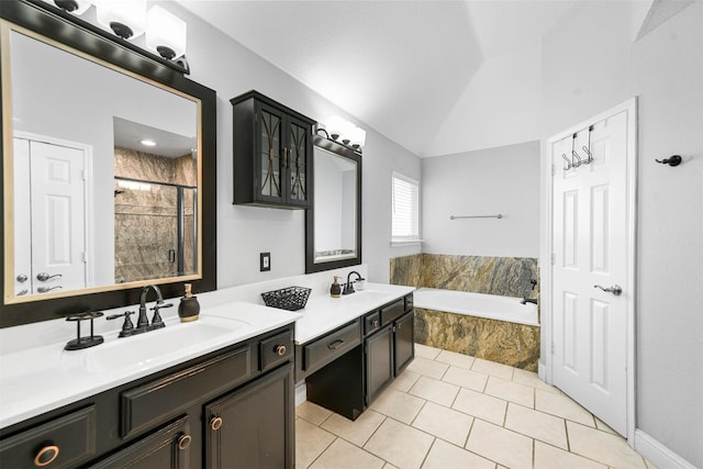 bathroom with tile patterned floors, lofted ceiling, independent shower and bath, and vanity