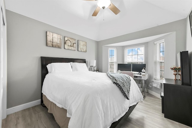 bedroom with vaulted ceiling, ceiling fan, and light wood-type flooring