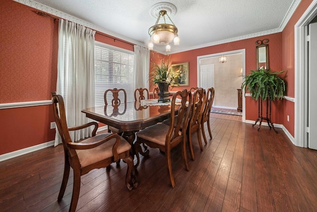 dining space with ornamental molding, dark hardwood / wood-style floors, and a textured ceiling