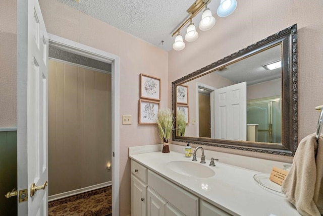 bathroom with vanity and a textured ceiling