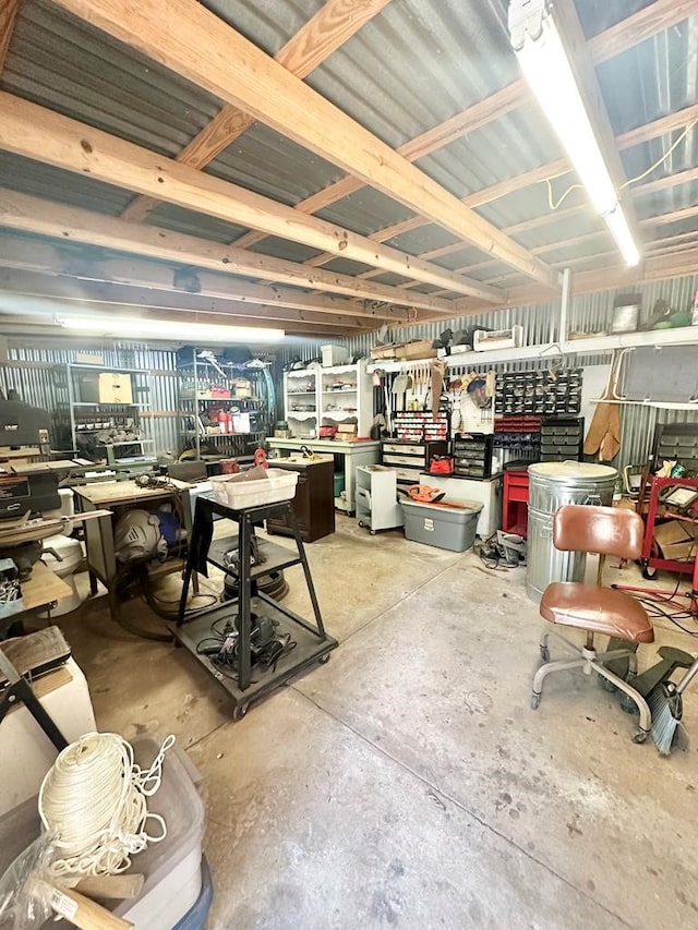 misc room featuring concrete flooring and a workshop area