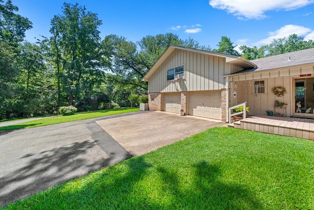 view of property exterior with a garage and a lawn