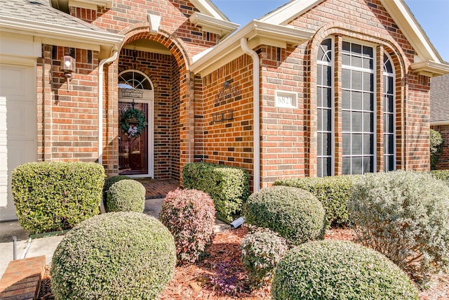 doorway to property with a garage