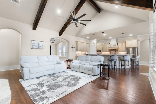 living room featuring arched walkways, high vaulted ceiling, dark wood-type flooring, and beam ceiling