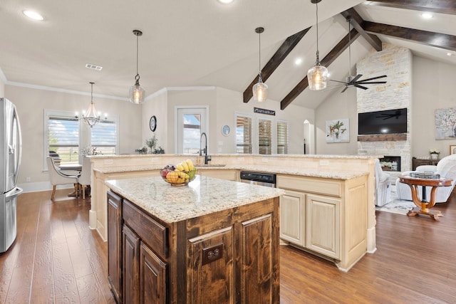 kitchen featuring a stone fireplace, a sink, visible vents, a large island, and dark wood finished floors