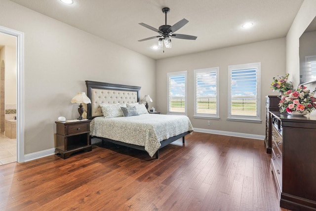 bedroom with recessed lighting, dark wood-style flooring, and baseboards