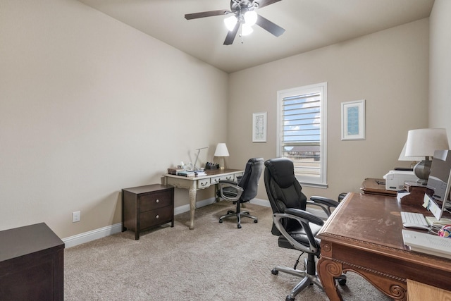 carpeted office featuring ceiling fan and baseboards