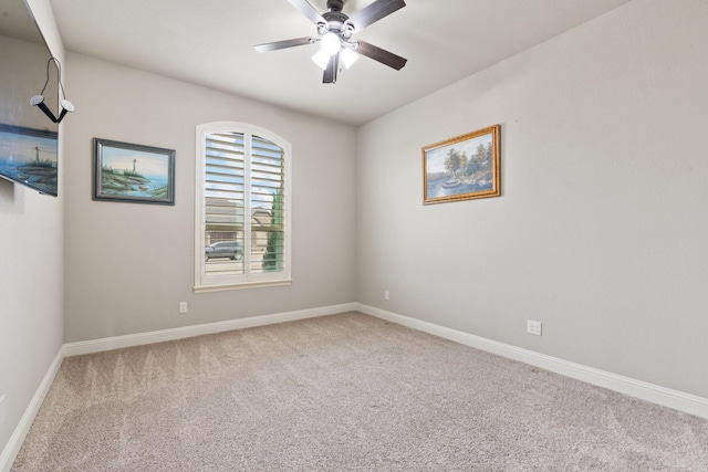 empty room with a ceiling fan, carpet flooring, and baseboards