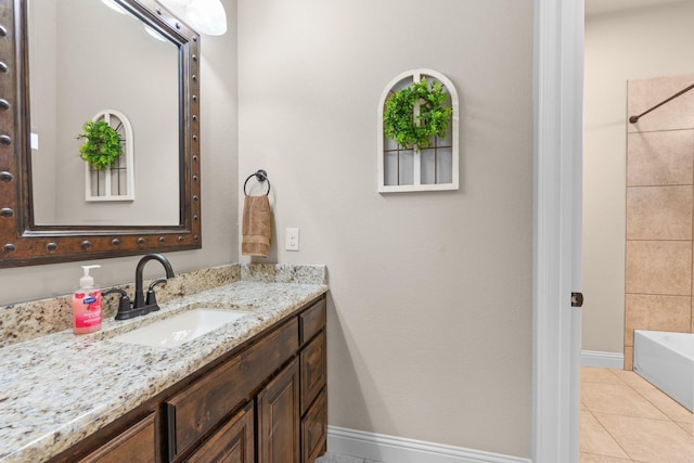 bathroom featuring vanity, baseboards, and tile patterned floors