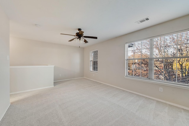 carpeted spare room with ceiling fan