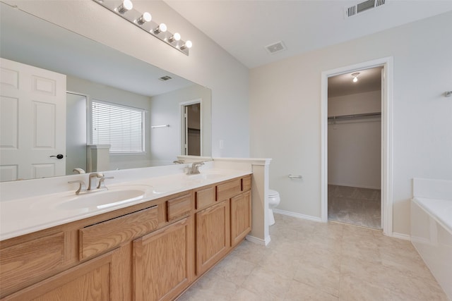 bathroom featuring vanity, toilet, and a bathtub