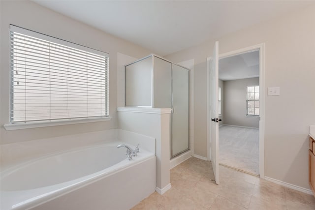 bathroom with tile patterned flooring, shower with separate bathtub, and vanity