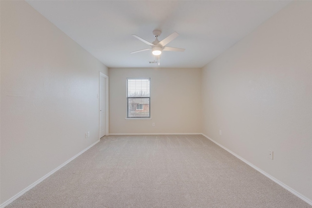 unfurnished room featuring light colored carpet and ceiling fan