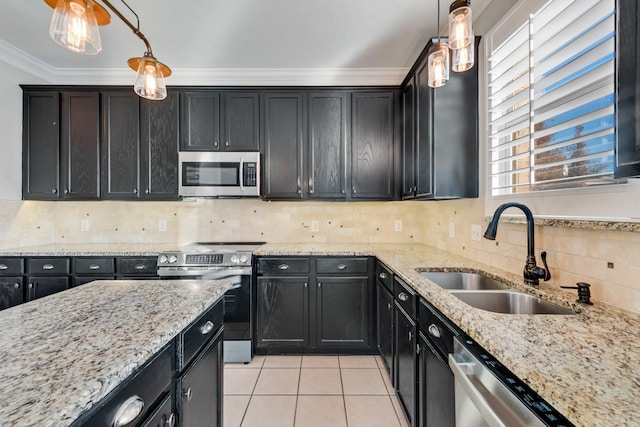 kitchen with decorative light fixtures, sink, light tile patterned floors, stainless steel appliances, and crown molding