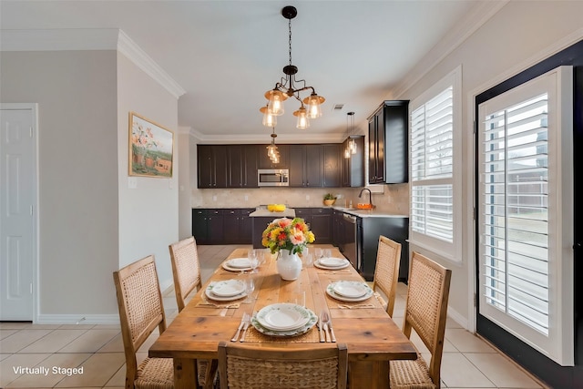 tiled dining space with crown molding, an inviting chandelier, and sink