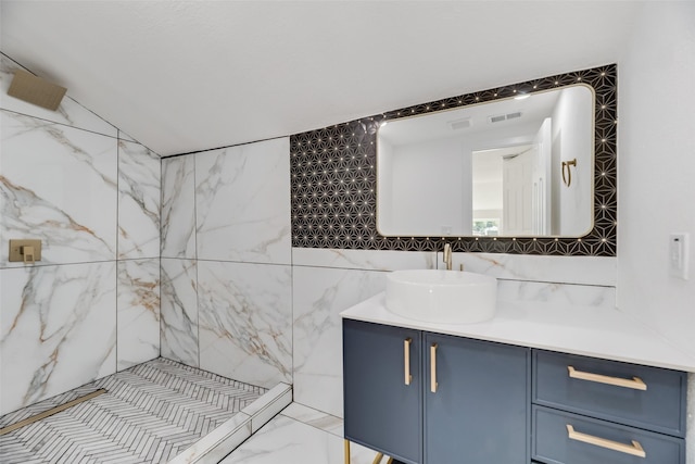 bathroom with vanity, tile walls, and a tile shower