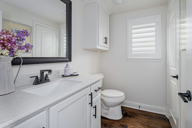 bathroom featuring vanity, hardwood / wood-style floors, and toilet