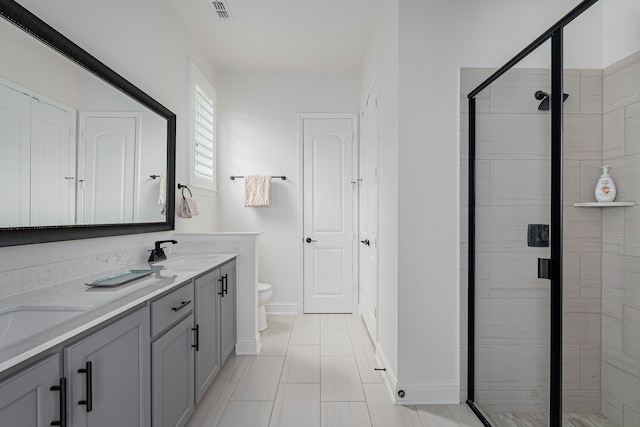 bathroom featuring vanity, toilet, and walk in shower