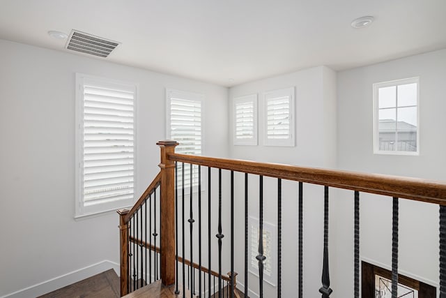 hallway featuring plenty of natural light and dark hardwood / wood-style flooring