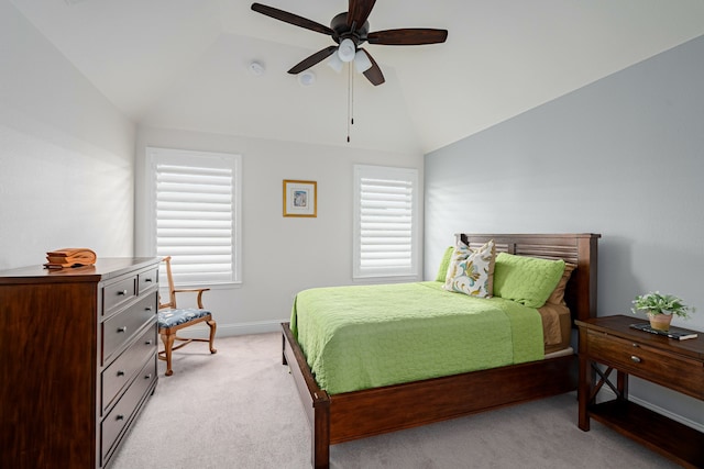 carpeted bedroom featuring multiple windows, vaulted ceiling, and ceiling fan