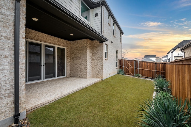 yard at dusk with a patio