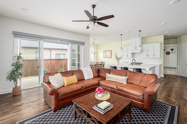 living room featuring sink, dark hardwood / wood-style floors, and ceiling fan