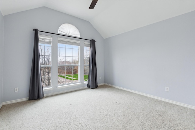 carpeted empty room featuring ceiling fan and vaulted ceiling