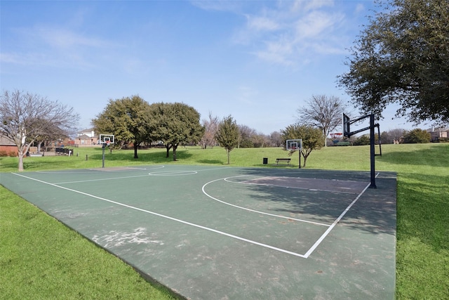 view of sport court with a yard