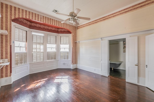 unfurnished bedroom featuring ornamental molding, dark hardwood / wood-style floors, and multiple windows