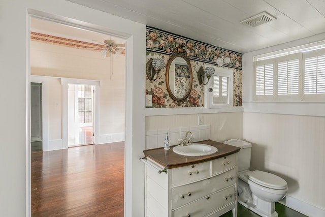 bathroom with vanity, ceiling fan, hardwood / wood-style flooring, and toilet