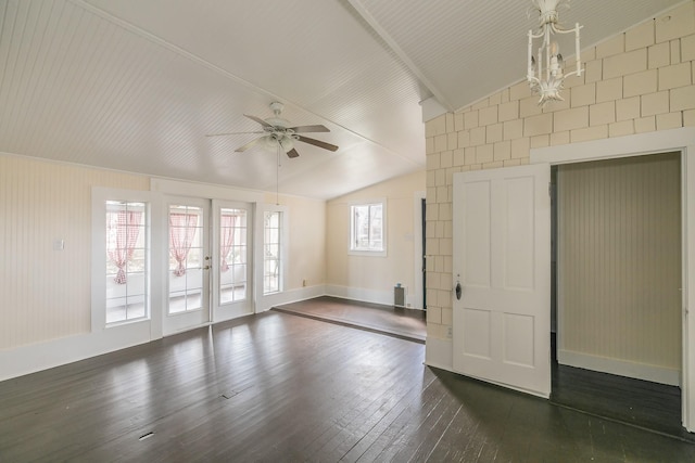 unfurnished room featuring lofted ceiling, ceiling fan with notable chandelier, dark hardwood / wood-style floors, and french doors