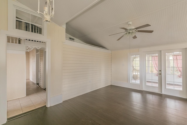 spare room featuring vaulted ceiling, ceiling fan with notable chandelier, and hardwood / wood-style floors