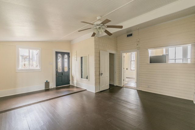 entrance foyer with wooden walls, vaulted ceiling, dark hardwood / wood-style floors, and ceiling fan