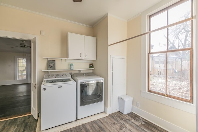 laundry area featuring crown molding, hardwood / wood-style flooring, ceiling fan, washing machine and dryer, and cabinets