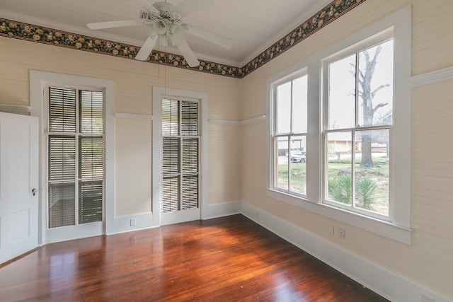 unfurnished room with dark wood-type flooring, ceiling fan, and ornamental molding