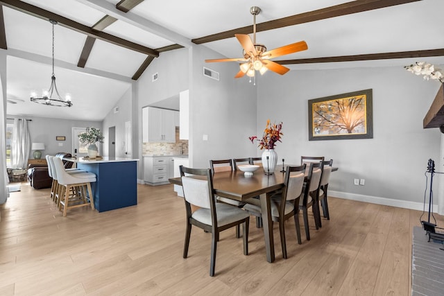 dining area with vaulted ceiling with beams, ceiling fan with notable chandelier, and light wood-type flooring