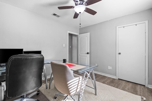 office space with wood-type flooring and ceiling fan