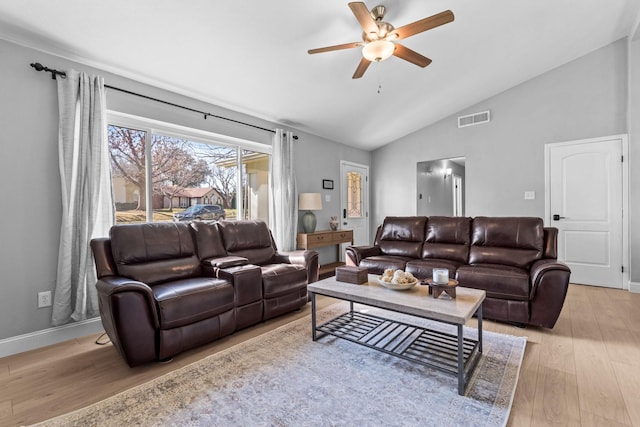 living room featuring vaulted ceiling, ceiling fan, and light hardwood / wood-style floors