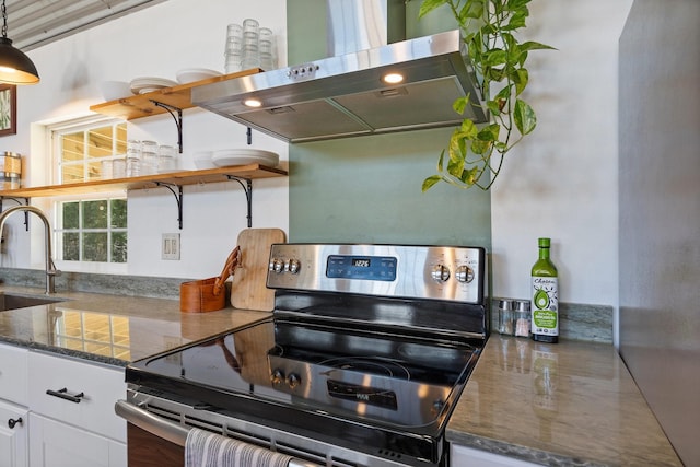 kitchen featuring decorative light fixtures, white cabinetry, sink, island exhaust hood, and electric stove