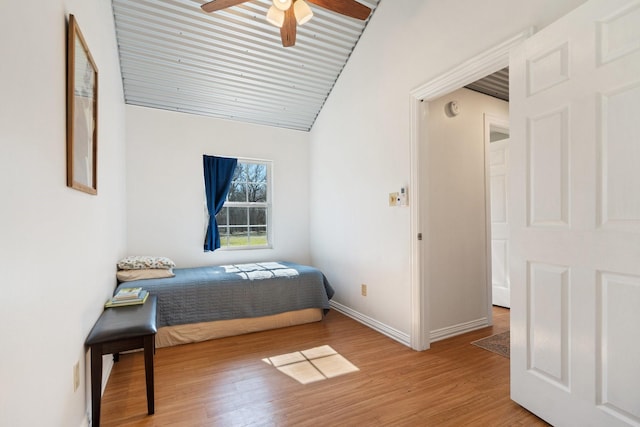 bedroom featuring lofted ceiling and light hardwood / wood-style flooring