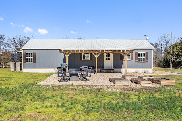 rear view of house featuring a patio and a yard