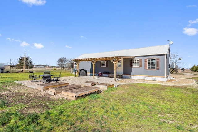 back of house with a patio area and a lawn