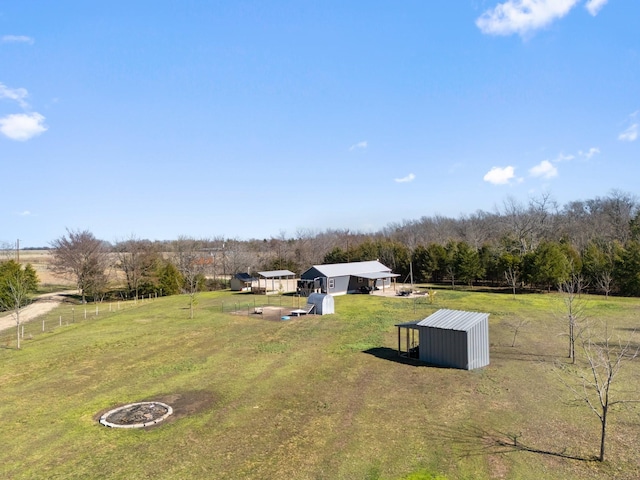 view of yard featuring an outdoor structure and a rural view