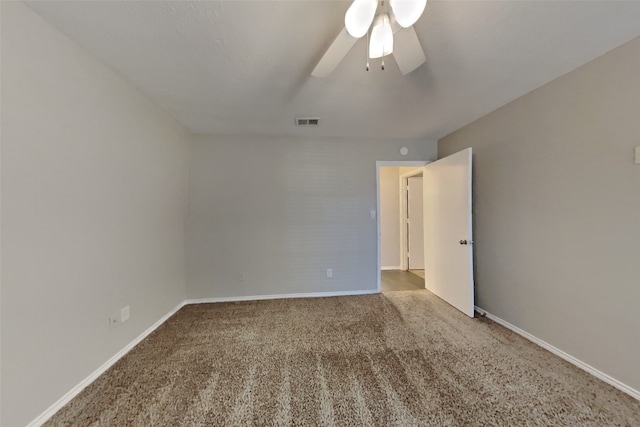 carpeted spare room with ceiling fan