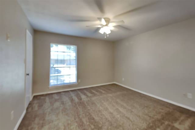 empty room featuring ceiling fan and carpet flooring