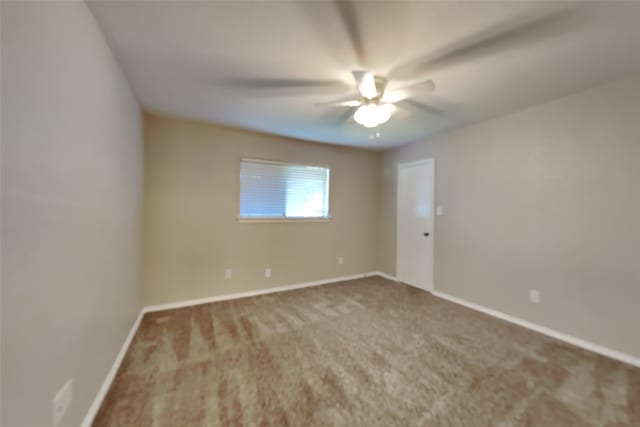 empty room with ceiling fan and carpet flooring